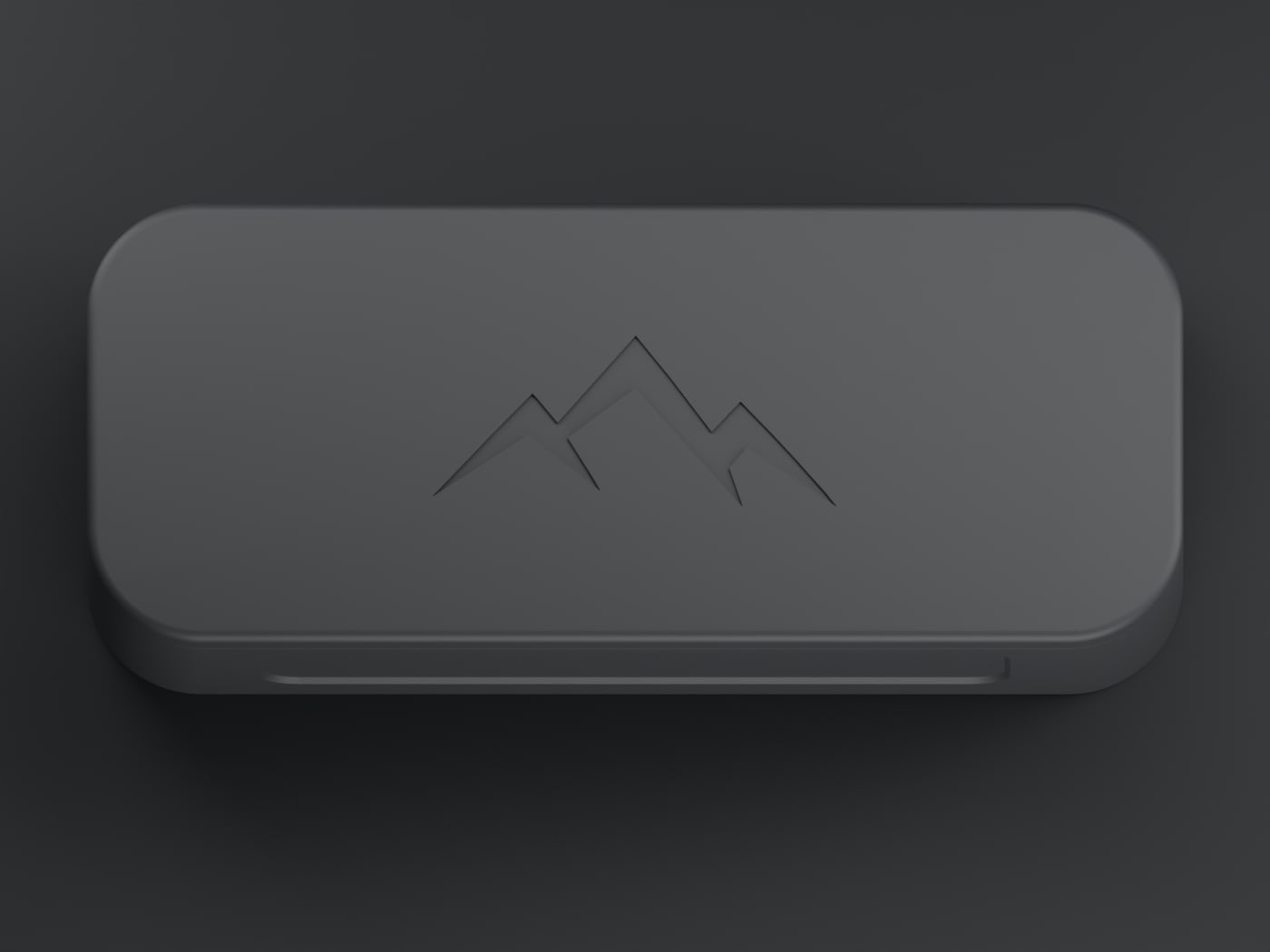 Top-down view of the NOMAE enclosure showing the debossed mountain mark centred on the lid